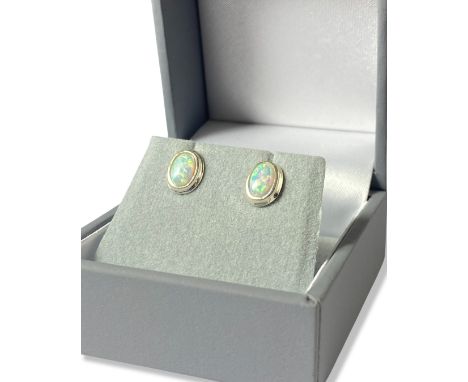 Pair of oval cut opal earrings set in silver mount weighing 0.91 grams 