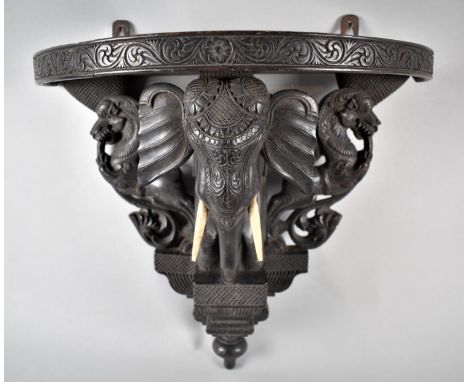 An Anglo Indian Colonial Demilune Shelf Sconce Carved with Lions and Central Elephant Support, 40cm wide and 36cm high 