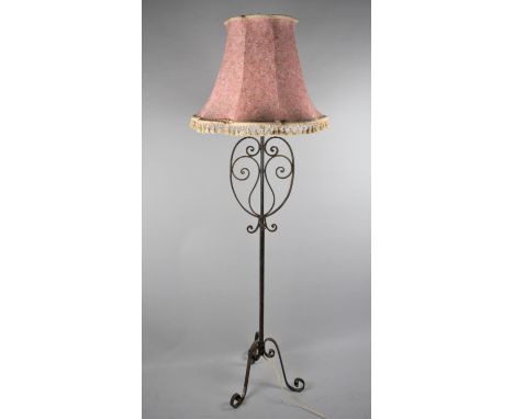 A Wrought Iron Standard Lamp on Tripod Support 