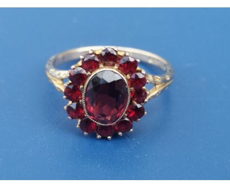 A Bohemian garnet set oval 9ct cluster ring.  Finger size K.