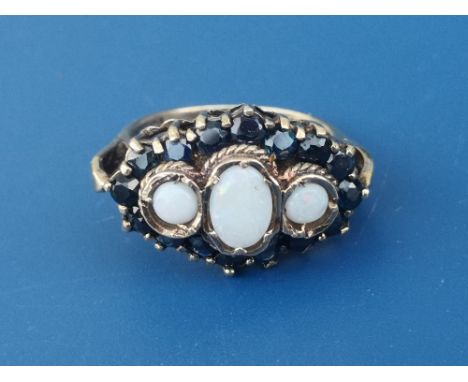 An opal &amp; sapphire set cluster style 9ct gold ring, having three central opals, London marks.  Finger size P.