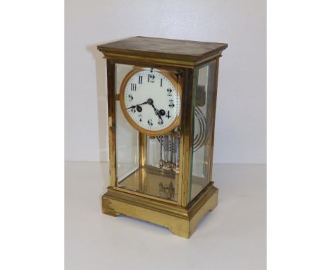 A four-glass gilt brass striking mantel clock with mercury pendulum, 10.75" high.