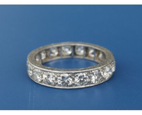 A diamond set white metal eternity ring, the 17 brilliant cut stones of total weight approximately 2 carats.  Finger size K/L