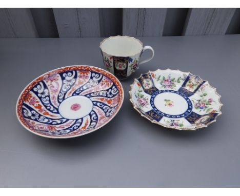 An 18thC Worcester porcelain teacup &amp; saucer, painted polychrome flowers between dark blue panels with gilding, fluted ri