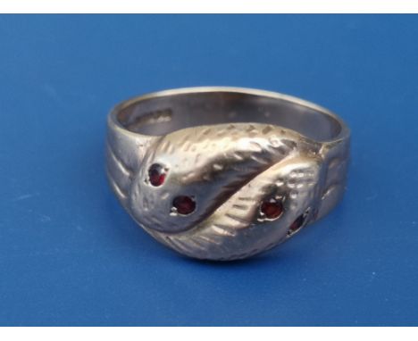 A 9ct gold band ring formed as two serpents with ruby/garnet eyes - Birmingham marks.  Finger size T.