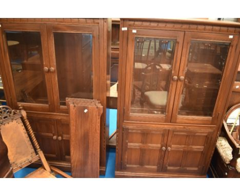 A pair of dark stained Ercol  bookcases, having double cupboards under, approx. dimensions W93 D34 H155cm