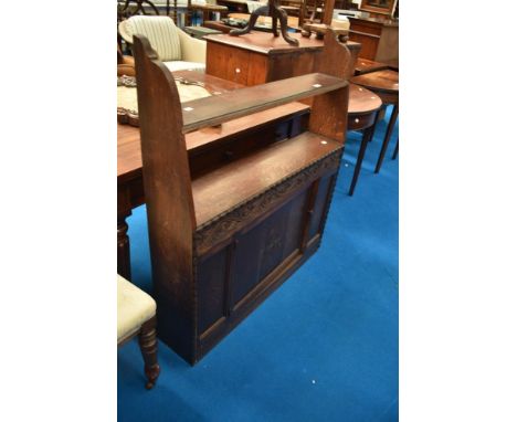 An early to mid 20th Century oak shelf with cupboard under, having open back, width approx. 97cm