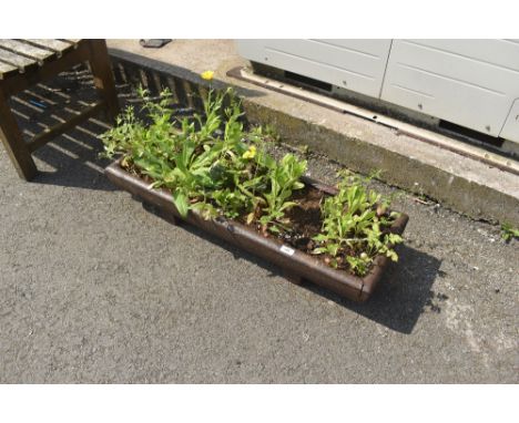 A cast iron trough planter