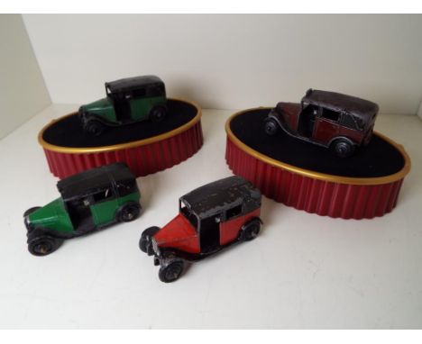 Dinky Toys - four model Taxis of which two x green and black, one red and black and one maroon and black, black diecast ridge