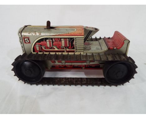 Marx Toys - a vintage clockwork Marx Crawler Tractor in red and grey model moves when wound. estimate £20 - £30