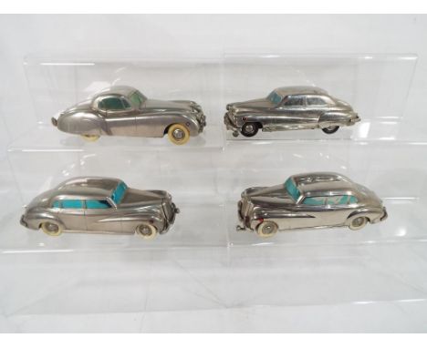 Prameta - four diecast clockwork model motor vehicles by Prameta to include a Jaguar XK120 in chrome with white wheels,a Buic