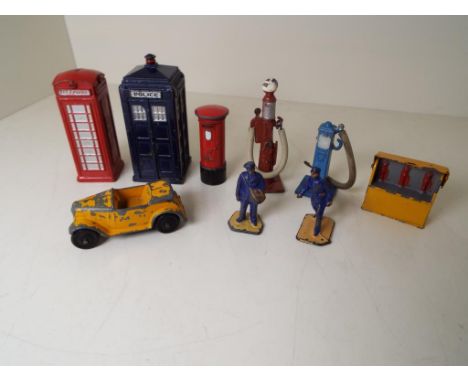 Dinky Toys - a telephone box, pillar box, police box, two petrol pumps, oil cabinet, two delivery figures and a yellow sports