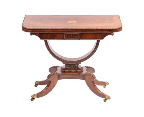 A well-drawn Regency mahogany fold-over "D" shaped gaming table with inlaid parquet fan-shaped boss, rosewood banding and spl