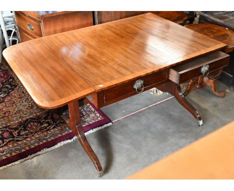 A Victorian satinwood cross-banded drop leaf sofa table, with twin frieze drawers opposing dummy drawer fronts, raised on tre