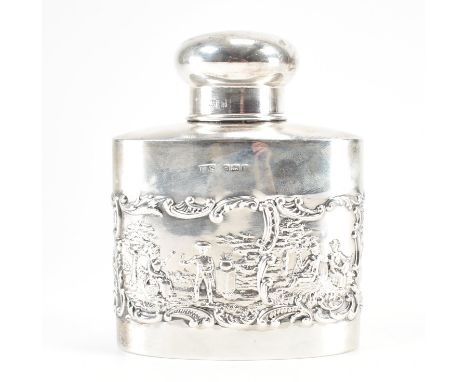 An Edwardian hallmarked silver stoppered flask. The flask having repousse decoration to the surround depicting pastoral scene