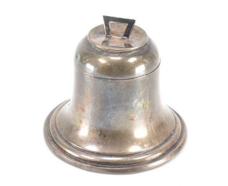 An early 20th Century silver hallmarked ink well in the form of a bell. The inkwell having a hinged lid with an angular finia