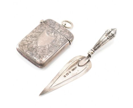 A Victorian silver trowel bookmark together with a silver vesta case. The trowel having a gadrooned handle with a pointed spa