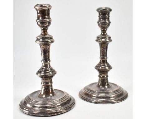 A near pair of vintage silver hallmarked candle sticks. The stick having round bases with knopped columns and sconces. One ha
