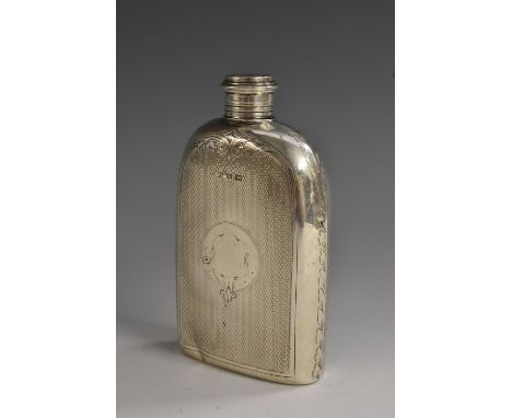 A Victorian silver hip flask, engine turned and centred by a gartered cartouche, engraved with leafy branches to shoulders an