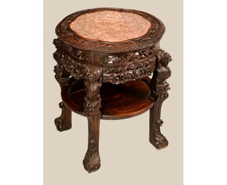 A Chinese hardwood circular fish bowl stand, shaped circular top with inset soapstone panel, above a deep frieze pierced and 