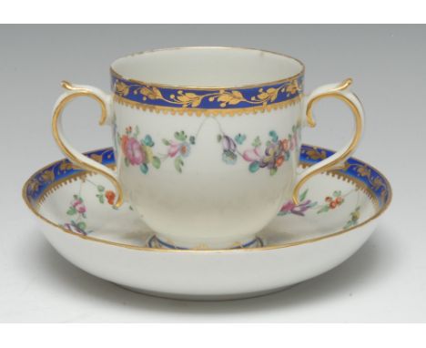 A Derby two-handled chocolate cup and stand, of earlier Chelsea-Derby form and decoration, painted in colourful polychrome wi