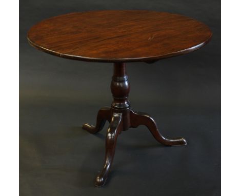 A George III mahogany tripod occasional table, circular tilting one piece top, turned baluster column, cabriole legs, pad fee