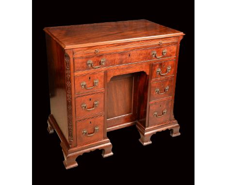 A Chippendale period mahogany kneehole desk, rectangular moulded top above a slide and a long frieze drawer, drawer and cupbo