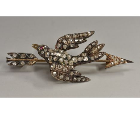 An Edwardian bird and arrow diamond sweetheart brooch, open body and Arrow bar pave encrusted with seventy old rose and mine 