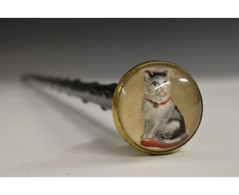 A 19th century novelty walking stick, the domed rock crystal pommel intaglio reverse carved and painted with a cat, ebonised 