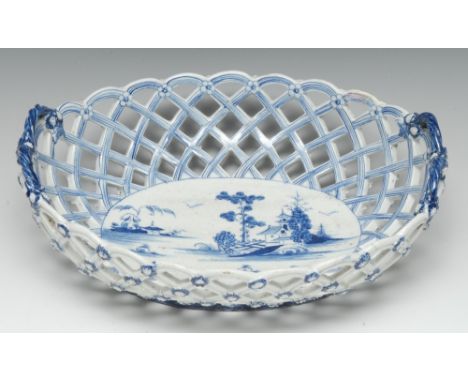 An early Derby two-handled oval basket, central oval reserve painted in underglaze blue with a stylized Chinese landscape, fa
