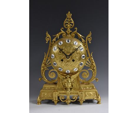 A 19th century French gilt metal mantel clock, 14cm domed dial inscribed with Roman numerals upon enamel cartouches, twin-win