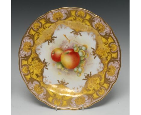 A Royal Worcester shaped circular cabinet plate, painted by E. Townsend, signed, with ripe apples and grapes on a mound of he