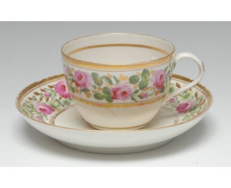 A Pinxton Bute-shaped teacup and saucer, painted with pink roses, green leaves and gilt foliage, gilt line borders, the sauce