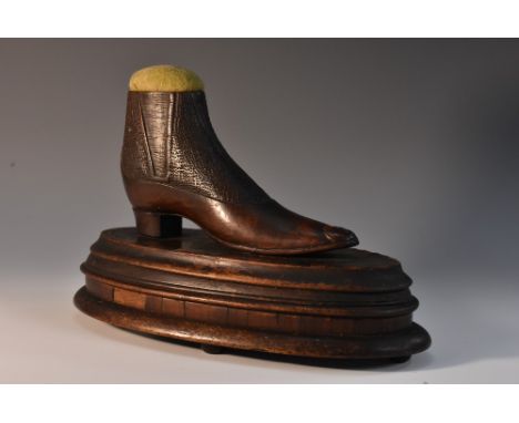 Treen - a large 19th century mahogany table top pin cushion, as a shoe, oval base with chequered border,bun feet, 23.5cm wide