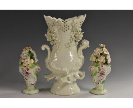 A pair of Derby Patch Mark Rococo cartouche-shaped vases, each modelled with a profusion of blossoming flowers and picked out