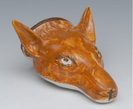 A Staffordshire Pearlware fox-mask stirrup-cup, painted in ochre shades, 13cm long, first quarter 19th century