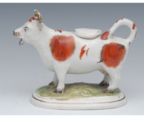 A 19th century Staffordshire cow creamer, standing four square, tan patch markings, oval base, 12cm high, c.1880