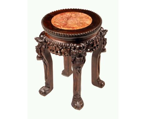 A Chinese hardwood jardiniere stand, circular top with beaded edge and inset soapstone panel, above a deep frieze pierced and