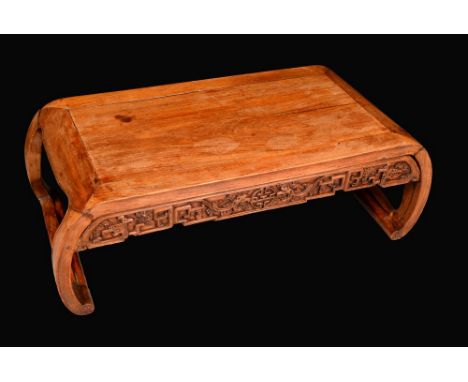 A Chinese hardwood low tea table, shaped frieze carved with dragons and shou character, scroll end supports, 27cm high, 83cm 