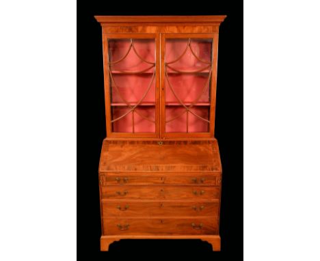 A George III Revival mahogany bureau bookcase, stepped cornice above a pair of glazed doors with a Neo-Classical urnular arra