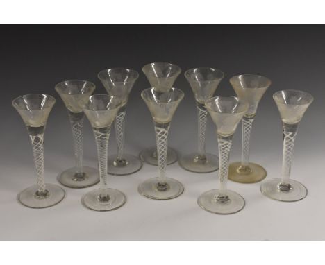 A set of ten 19th century trumpet shaped opaque twist wine glasses, each bowl engraved with roses, circular bases, 18.5cm hig