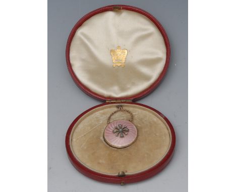 A gold coloured metal diamond and rose guilloche enamel circular pendant, centred with stylised flowerheads, 2.5cm diam, moro