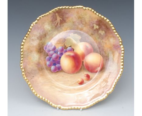 A Royal Worcester shaped circular plate, painted by J. Skerrett, signed, with ripe apples and grapes on a mossy ground, gilt 
