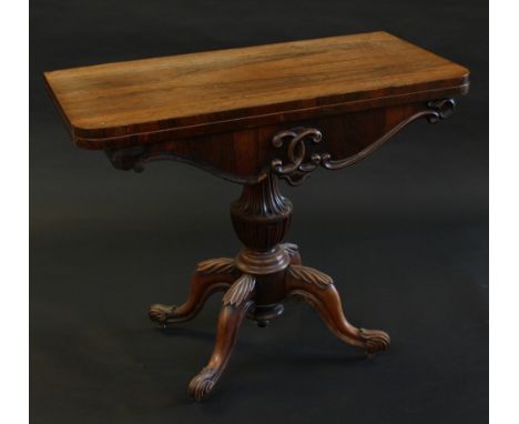 A William IV rosewood D-shaped card table, folding top enclosing an inset baize lined playing surface above a shaped frieze, 