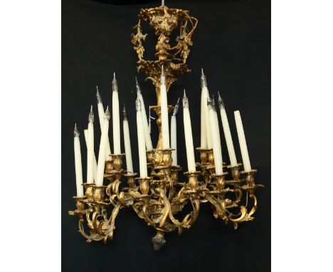 A Rococo Revival gilt metal eighteen-light chandelier, cast throughout with scrolling acanthus, campana sconces, 91cm high, 7