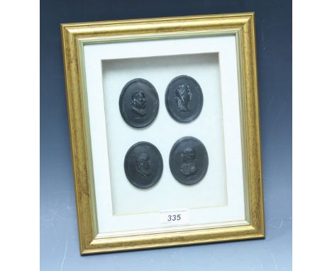 A set of four Wedgwood black basalt oval portrait plaques, Socrates, others, each 6cm high, framed as one
