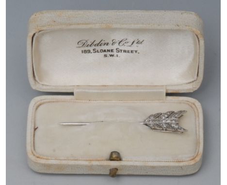 A diamond set white metal pin, as an arrow, the flight set with twenty two brilliant cut stones, monogrammed for Lady Elizabe