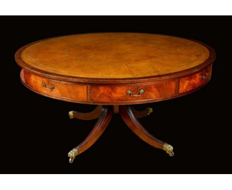 A George III Revival mahogany library or rent table, circular top with inset tooled and gilt leather writing surface, above f