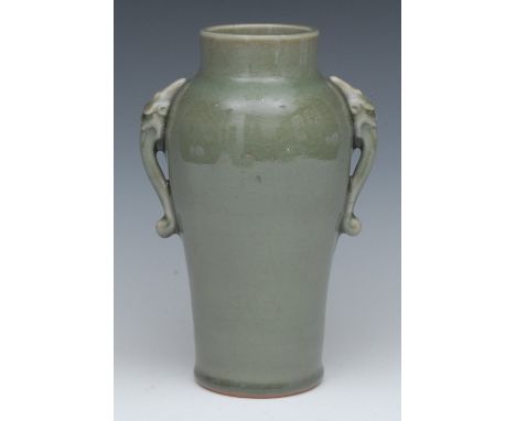 A Chinese celadon ovoid vase, with elephant scroll handle, pierced hardwood bases, 23cm high, 19th century Provenance: From t