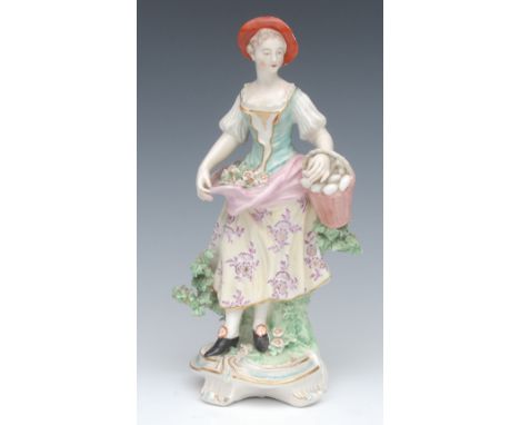 A Derby Patch Mark figure, of a Shepherdess, she stands, with flowers in her apron, wearing a broad brimmed hat, holding a ba